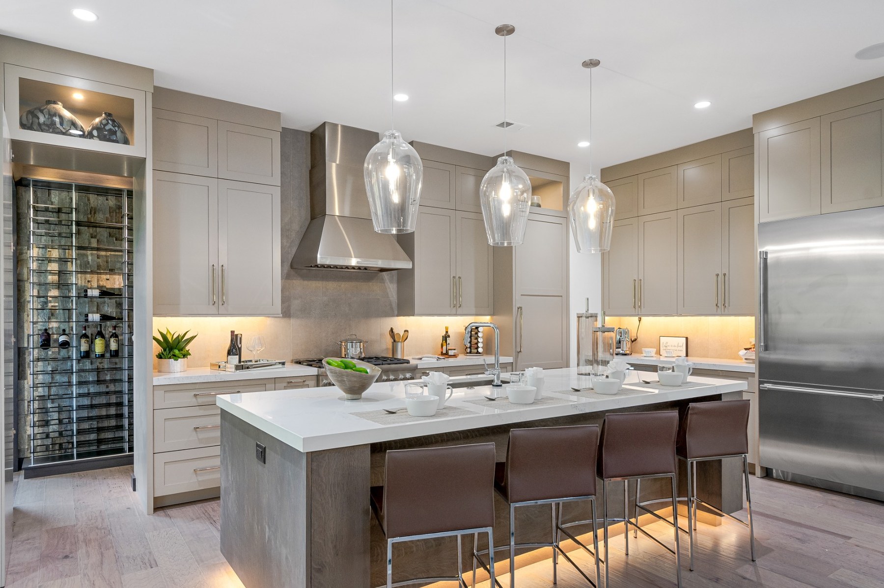 Warm neutral kitchen with layered lighting and refined cabinetry.